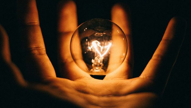 Photo of hand holding lightbulb