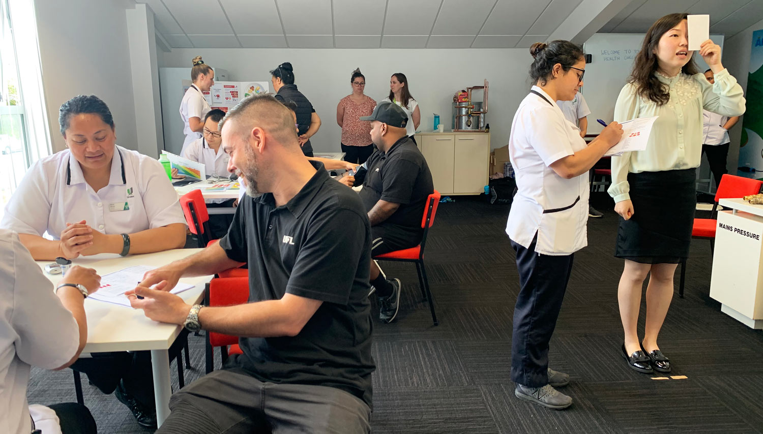 Photo showing various people taking part in health checks